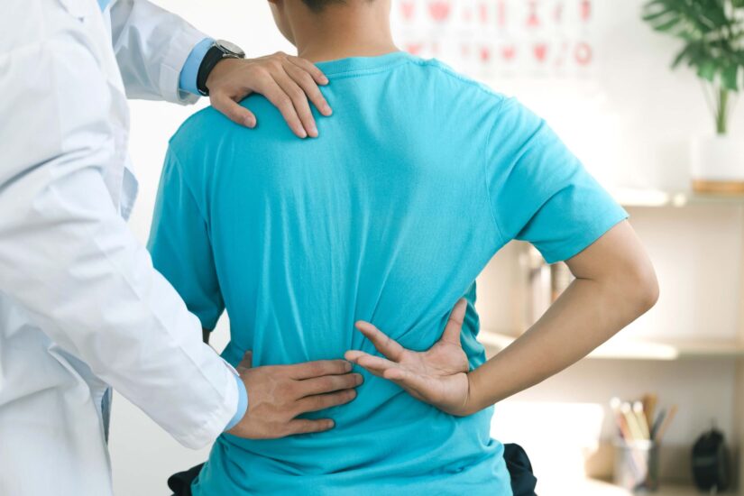 Physiotherapists treat lower back pain in patients in the hospital